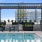 The outdoor lounge and pool area at our apartments for rent in Raleigh, NC, featuring lounge chairs and a shade structure.