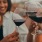 People holding their wine glasses together at our apartments, featuring a text overly reading 
